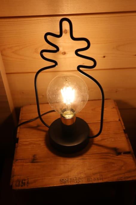 a lamp with a christmas tree light on a table at Le petit Gambetta in Belfort