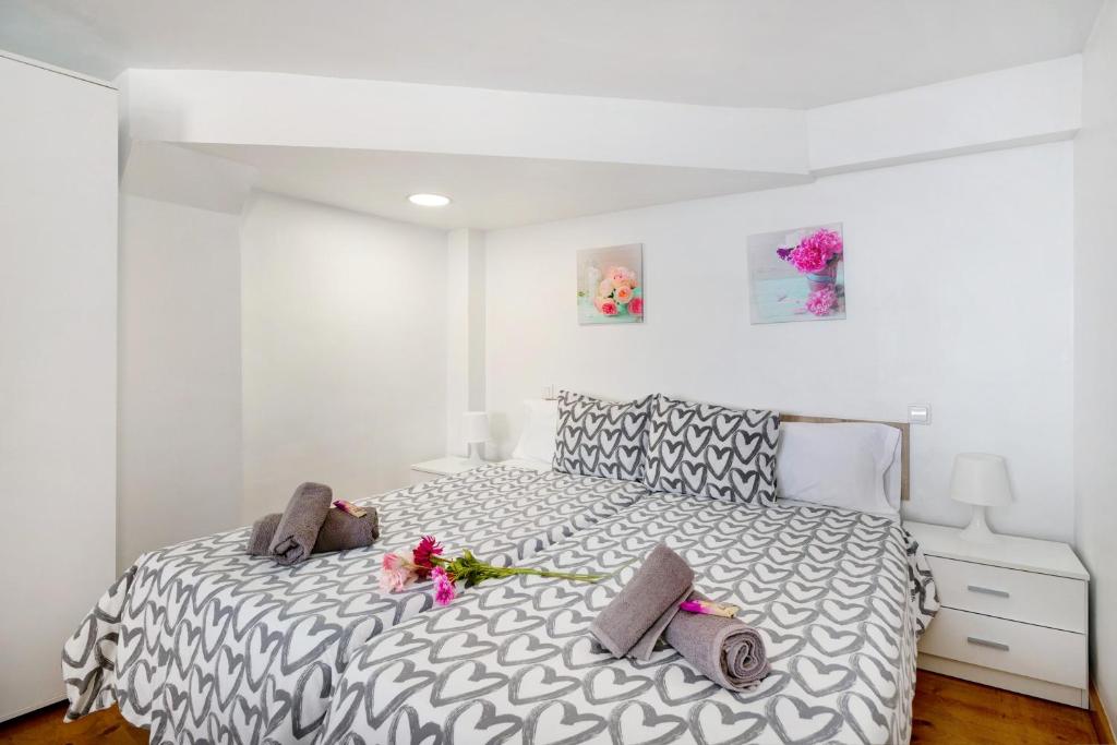 Un dormitorio con una cama con flores rosas. en Lanzarote 4 U, en Arrecife