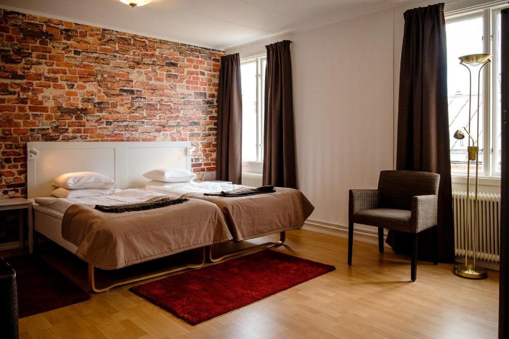 Postel nebo postele na pokoji v ubytování Eksjö Stadshotell Annex