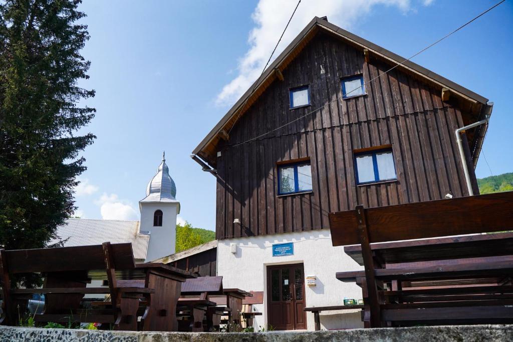 un gran edificio de madera con una torre de reloj en Planinarski dom ''Bijele stijene'' Mountain lodge, en Tuk Vojni