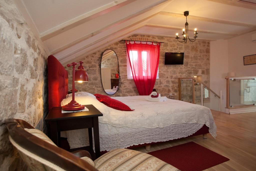 a bedroom with a bed with a red curtain at Bed & Breakfast Vila Baguc in Split