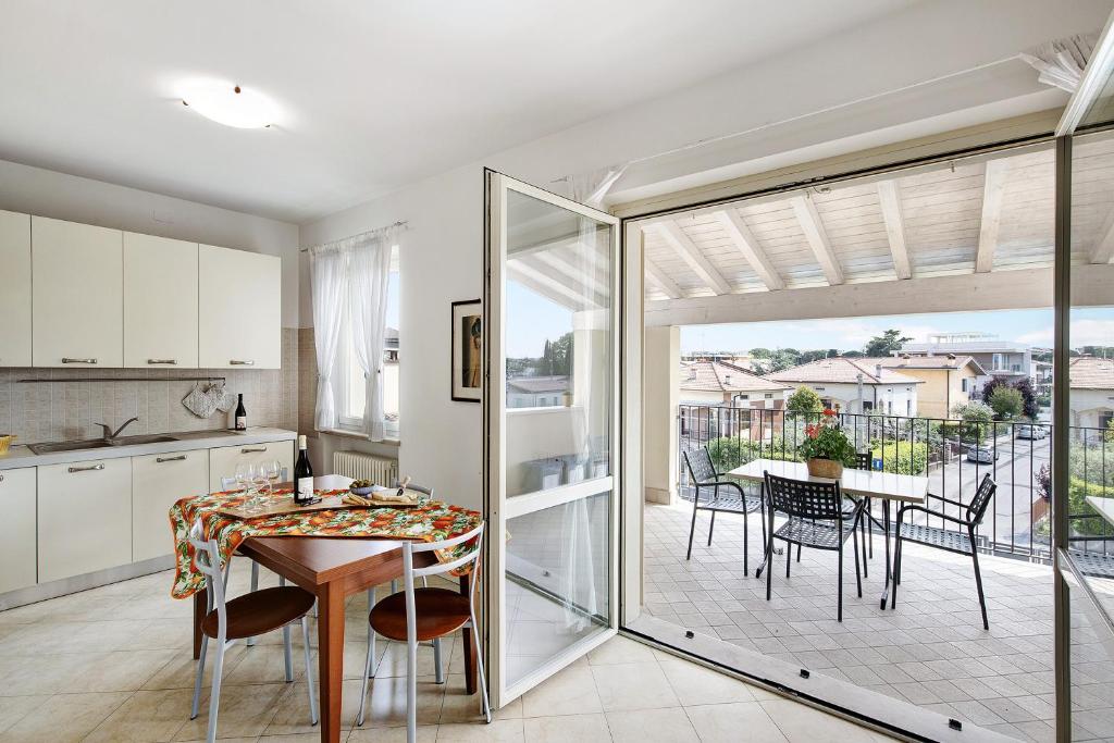 a kitchen and dining room with a table and chairs at Katy Lake 2 in Desenzano del Garda