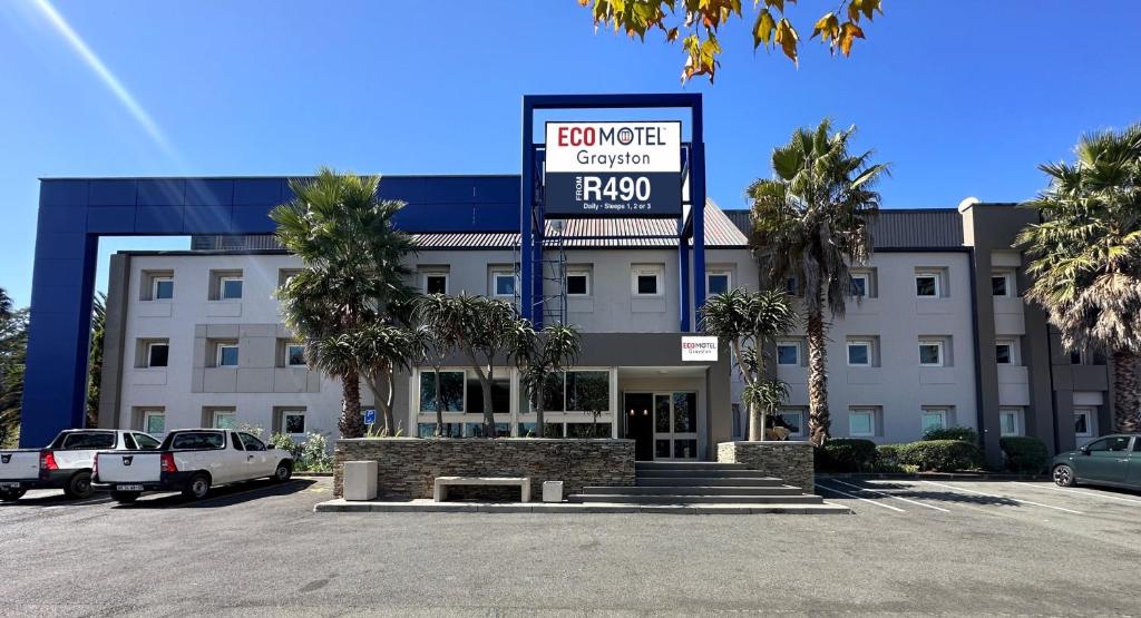 a hotel with a sign in front of a parking lot at Ecomotel Grayston previously known as SUN1 Wynberg in Johannesburg