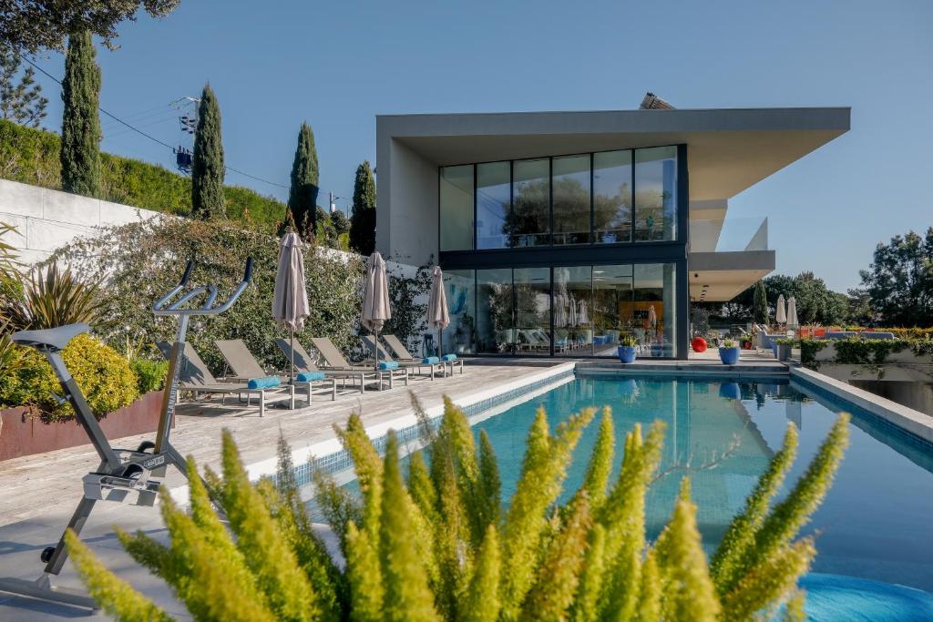a villa with a swimming pool and a house at Villa Paladina in Foz do Arelho