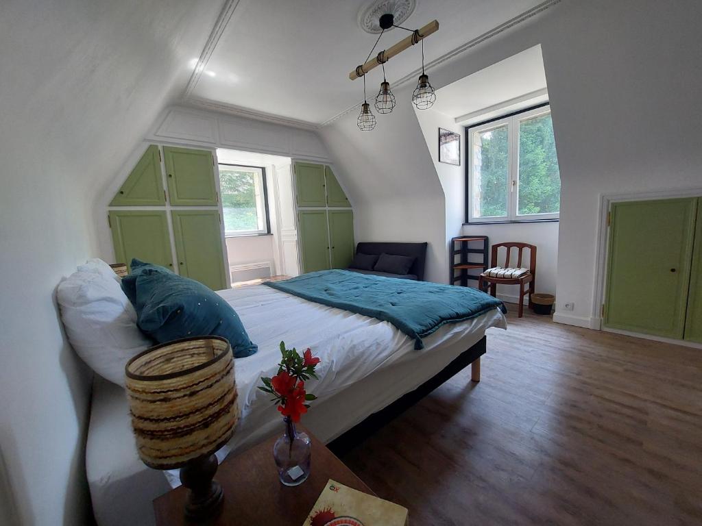 ein Schlafzimmer mit einem Bett und einem Tisch darin in der Unterkunft L'échappée, Chambres et Tables d'hôtes in Saint-Fiacre