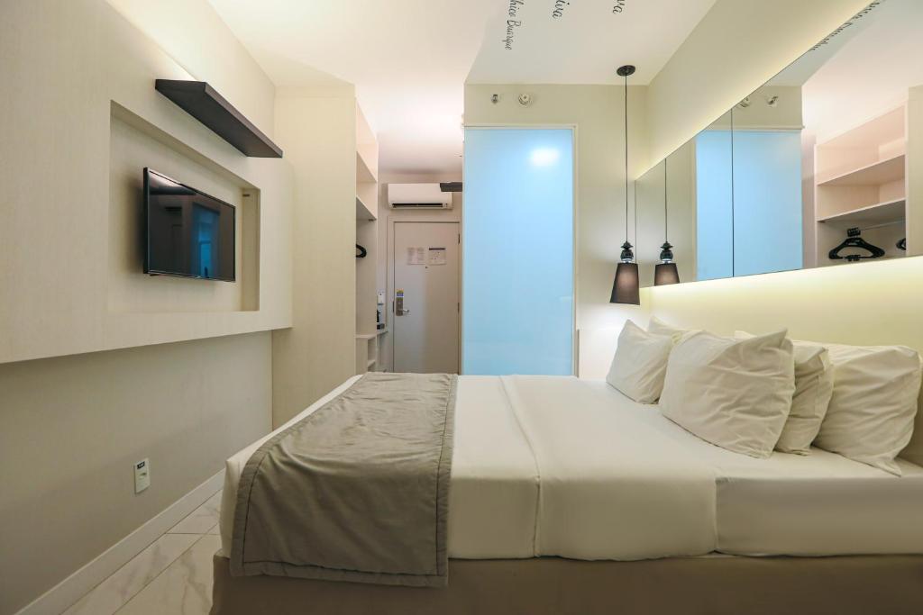 Una cama o camas en una habitación de Nobile Hotel Copacabana Design