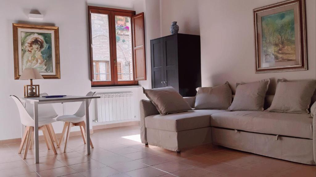 a living room with a couch and a table at Civico in Gubbio