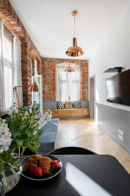 a living room with a table with a plate of food at Central Apartamenty in Jelenia Góra