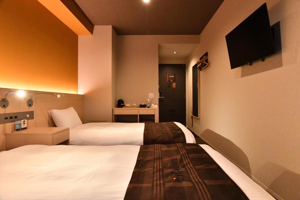 Postel nebo postele na pokoji v ubytování FL Hotel Dotonbori
