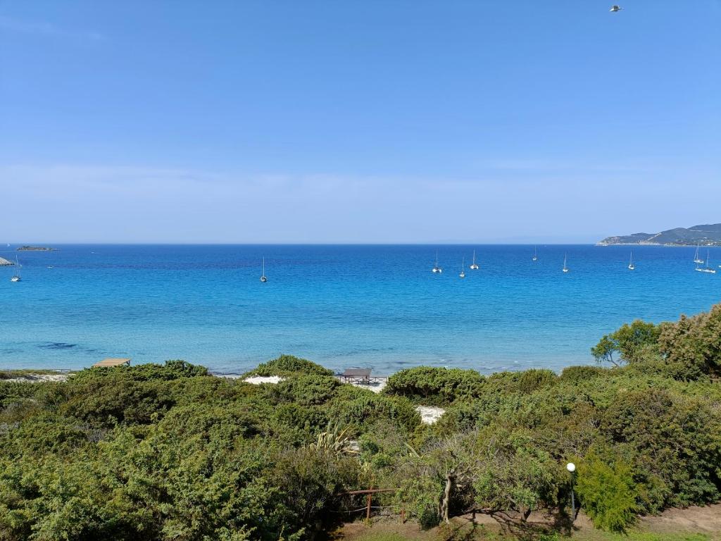 a view of a beach with boats in the water at Villa Tre Mari in Villasimius