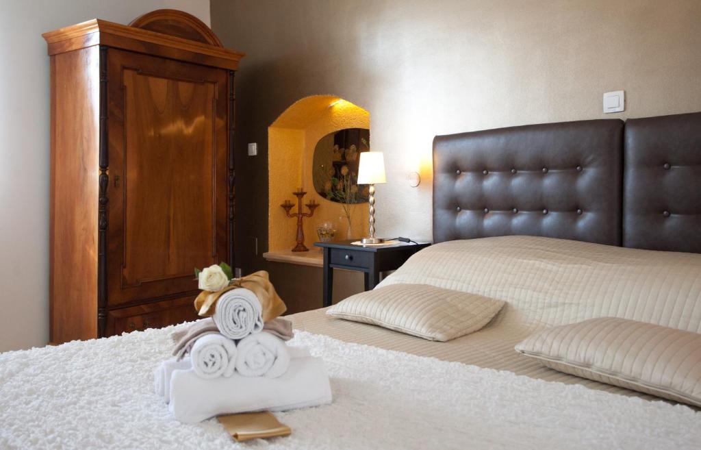 a bedroom with a bed with towels on it at Bed & Breakfast Vila Baguc in Split