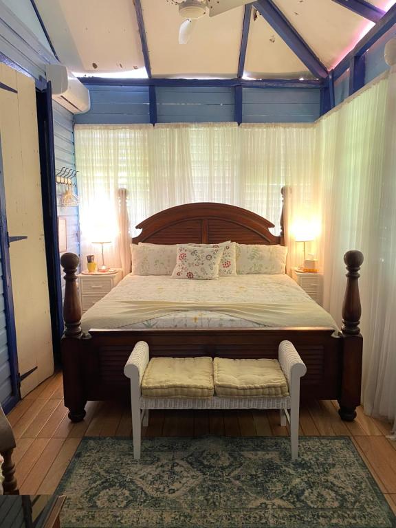 a bedroom with a large bed with a bench in it at Campito Loving in Higuey