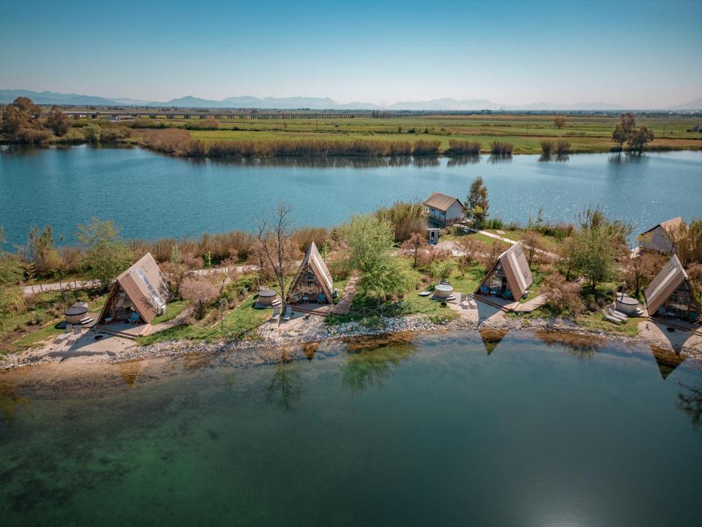 an aerial view of a lake with a house at Nabi Resort Glamping & SPA in Castel Volturno