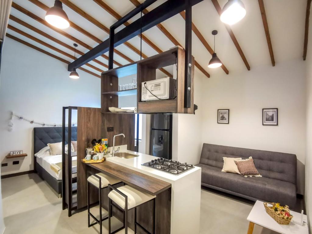 a kitchen and living room with a couch at Casa García Rent Home in Guatapé