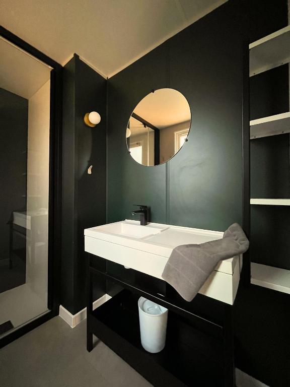 a bathroom with a white sink and a mirror at Camping Sunêlia la Clémentine in Cendras