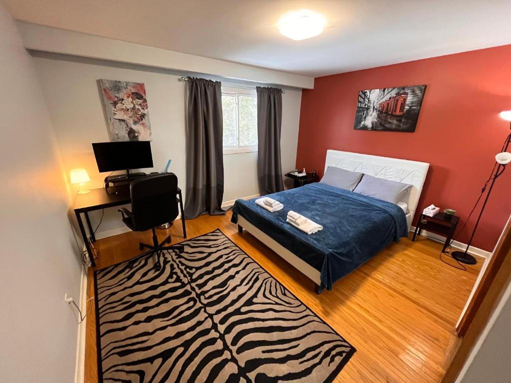a bedroom with a bed and a zebra rug at Spacious private room near Finch station in Toronto