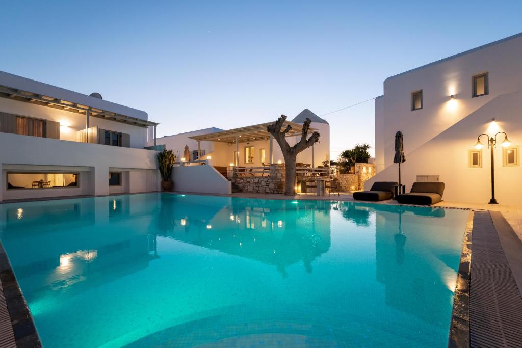 a large swimming pool in front of a building at Anemomylos Residence in Naousa