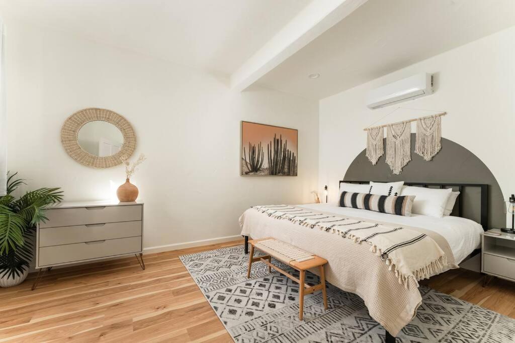 a bedroom with a large bed and a mirror at 1 Bedroom Casita - Casa Blanca in Montecito