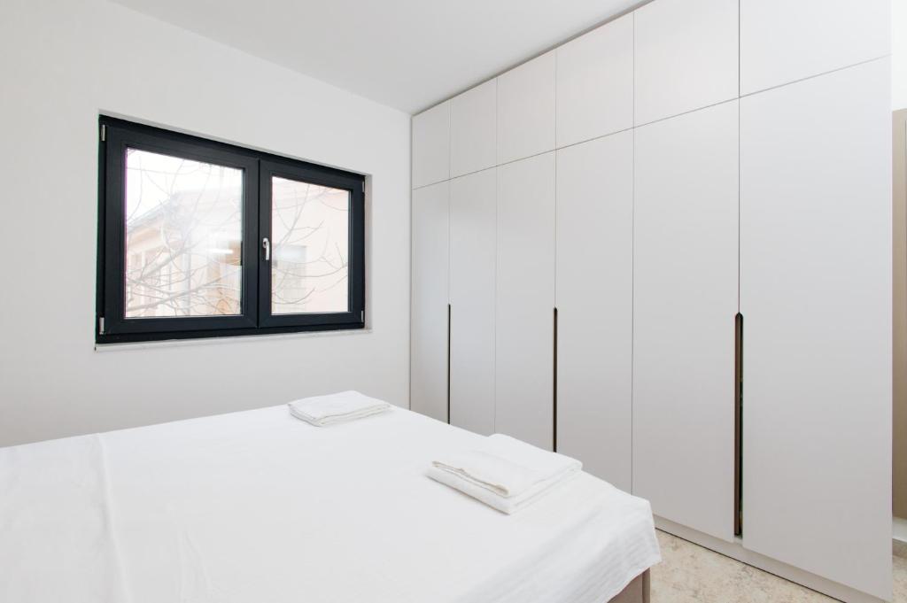 Postel nebo postele na pokoji v ubytování Lira Suites