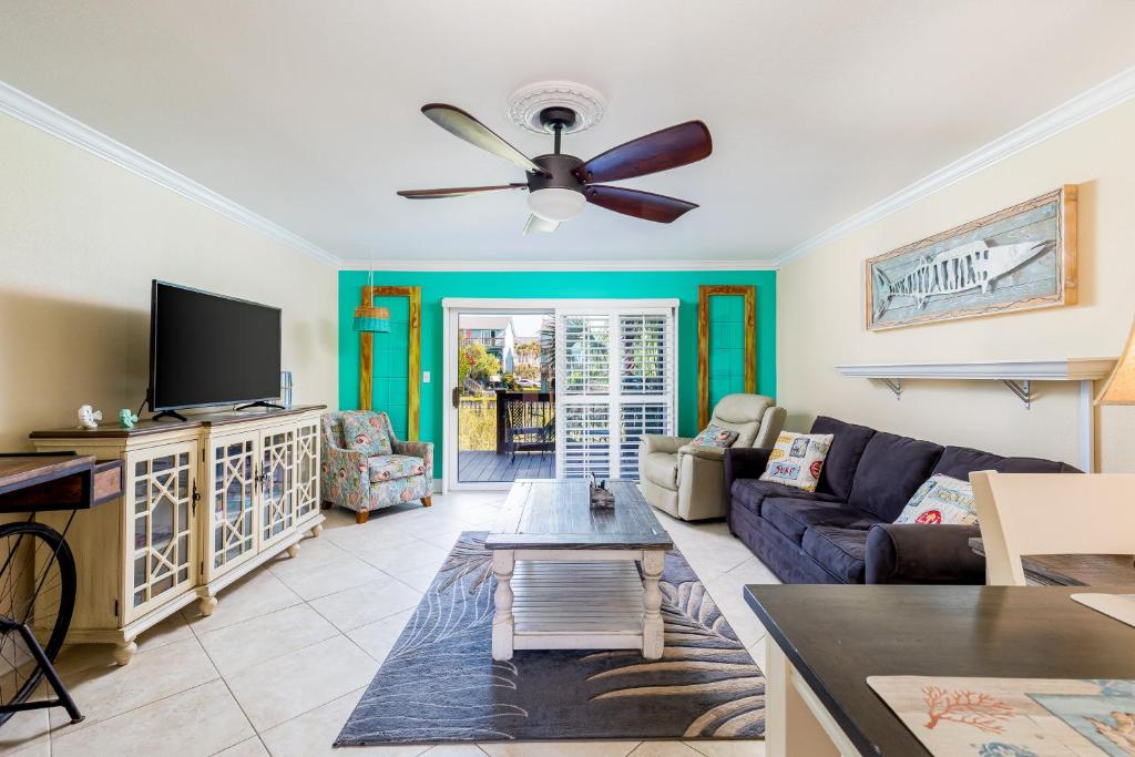 a living room with a couch and a ceiling fan at Coastal Haven in Pensacola Beach