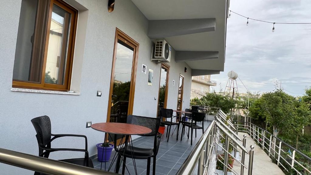 a balcony with chairs and a table on a building at Serene Stay in Vlorë