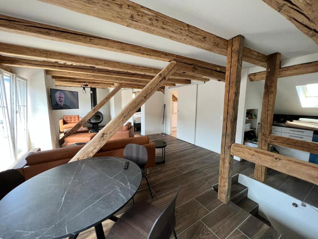 ein Wohnzimmer mit Holzbalken und einem Tisch in der Unterkunft stattHotel in Zürich