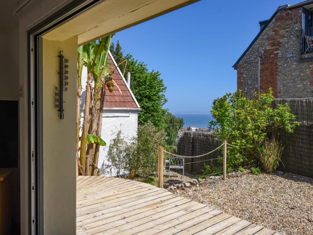 a door to a house with a wooden walkway at The Old Garage in Lyme Regis