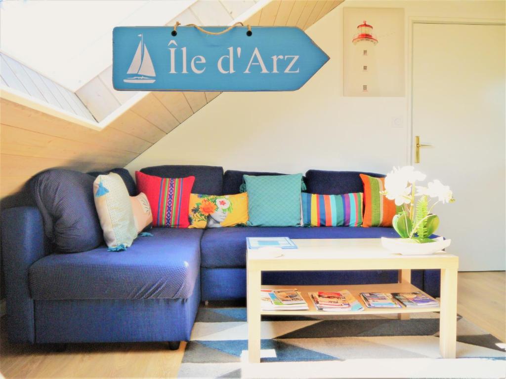 a blue couch in a living room with a table at 13K Arz in Vannes