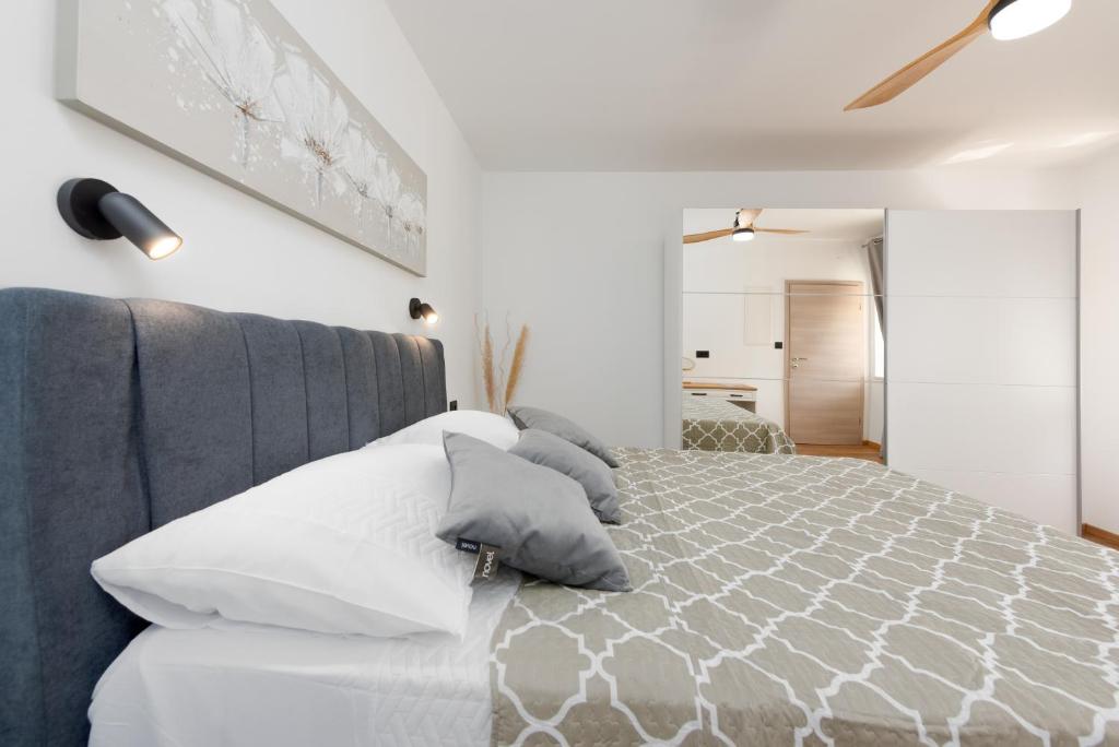 a bedroom with a bed with white pillows at Casa Fiumana Laura in Rijeka