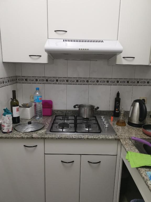 a kitchen with a stove with a pot on it at ARIN alojamientos in Lleida