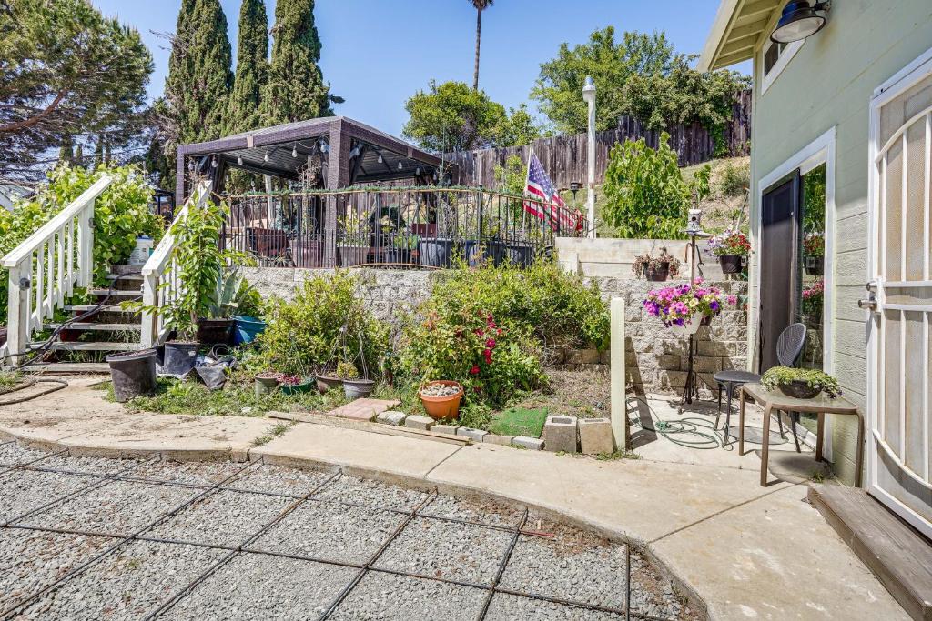 a house with a garden with a fence and stairs at Lush Vallejo Cottage - 20 Mi to Napa Wineries in Vallejo