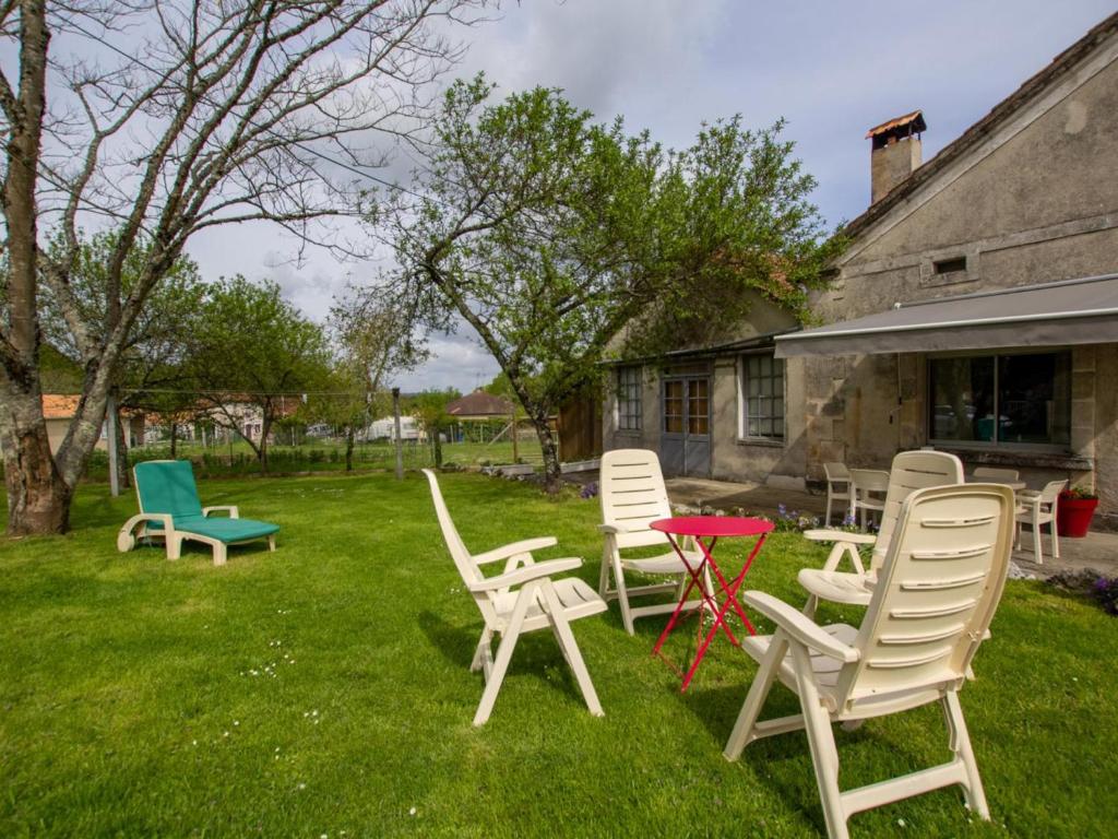 a group of chairs and tables in a yard at Gîte Tocane-Saint-Apre, 4 pièces, 6 personnes - FR-1-616-314 in Tocane-Saint-Apre