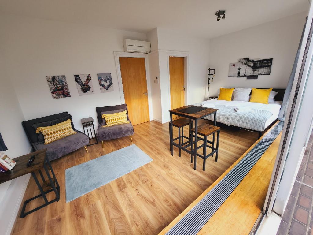 a living room with a bed and a table at Top Floor Room in Baker St in London