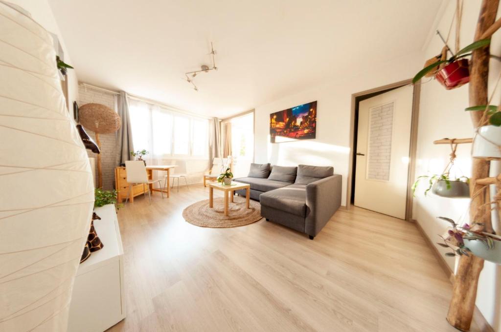 a living room with a couch and a table at La Cuccia - Fully furnished apartment close to metro and Olympic venues in Châtillon