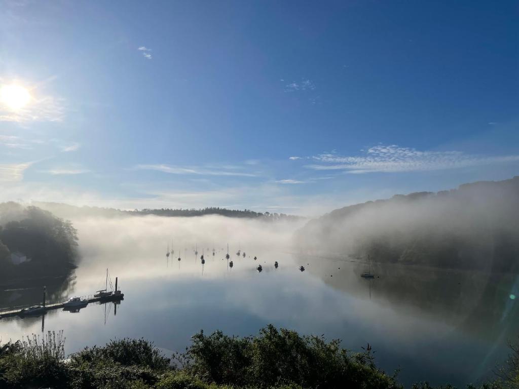 a view of a lake with fog on the water at 4 Trenhaile Terrace in Truro