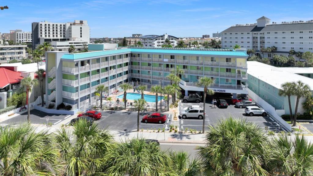 an aerial view of a hotel with a parking lot at Pelican Pointe Hotel in Clearwater Beach