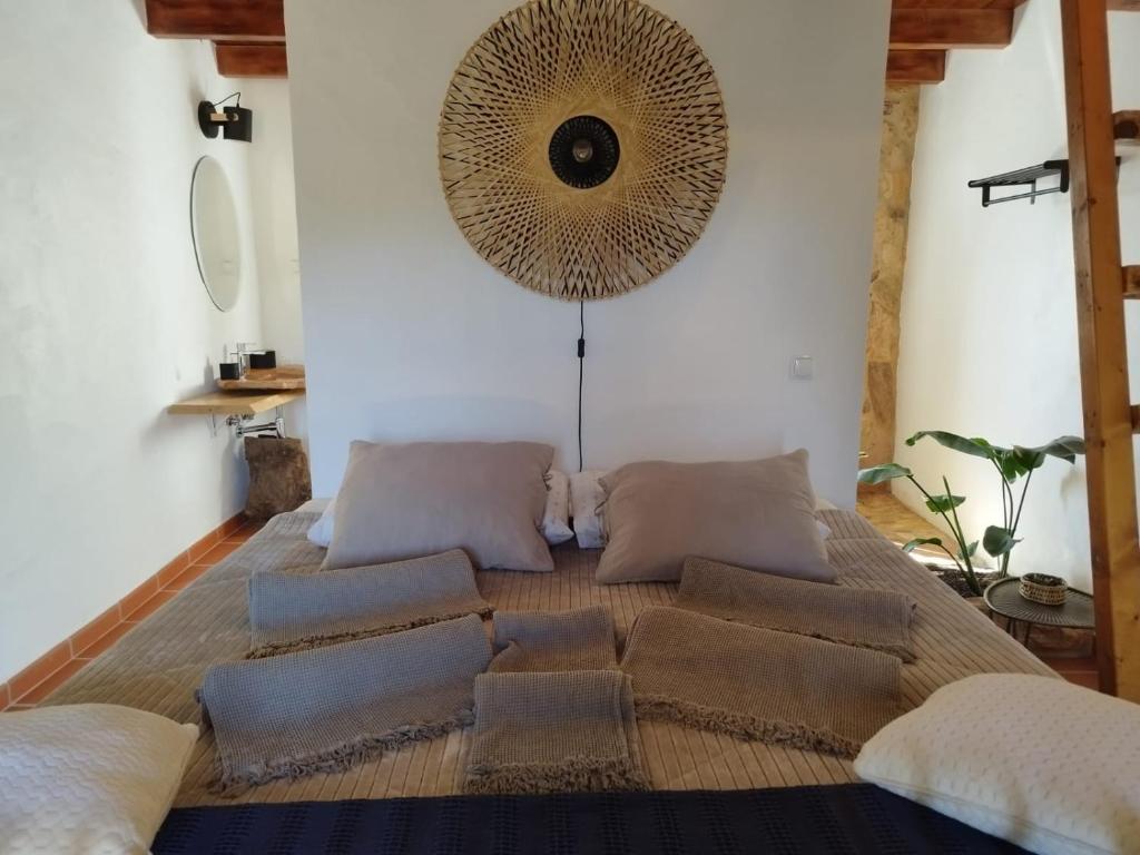 a bedroom with a large bed with pillows on it at Herdade da Maceira in São Luis