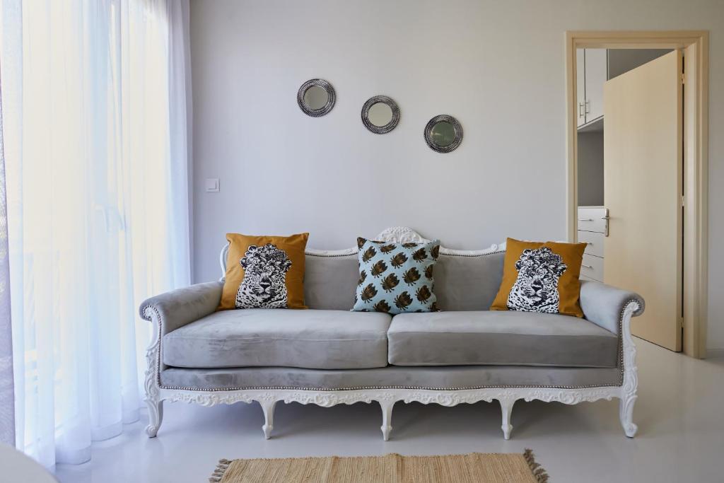 a living room with a couch with pillows on it at Mosaic Cosy House in Chios