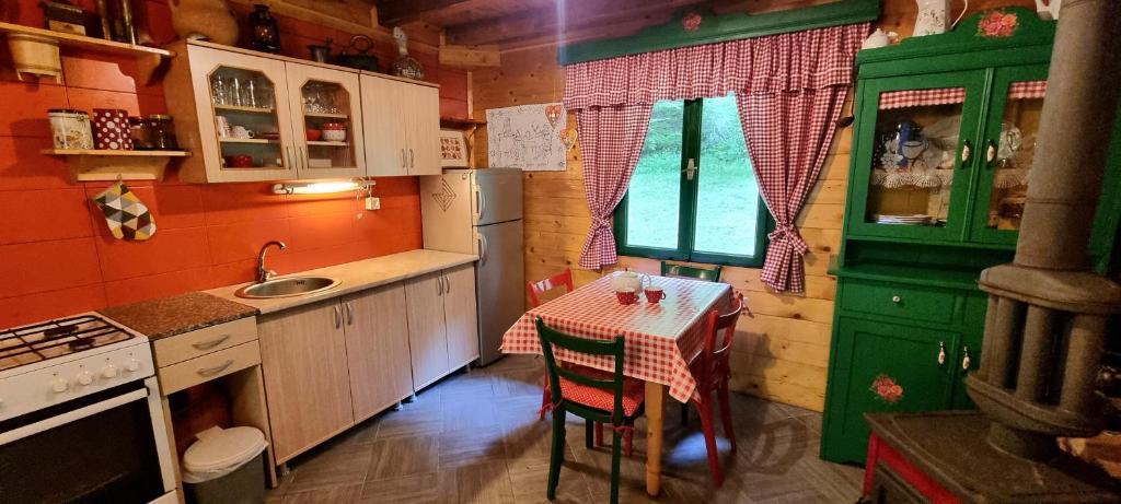 a small kitchen with a table and a sink at Naša kuća-Veruša in Veruša