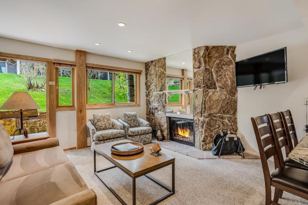 a living room with a fireplace and a tv at Laurelwood Condominiums 403 in Snowmass Village