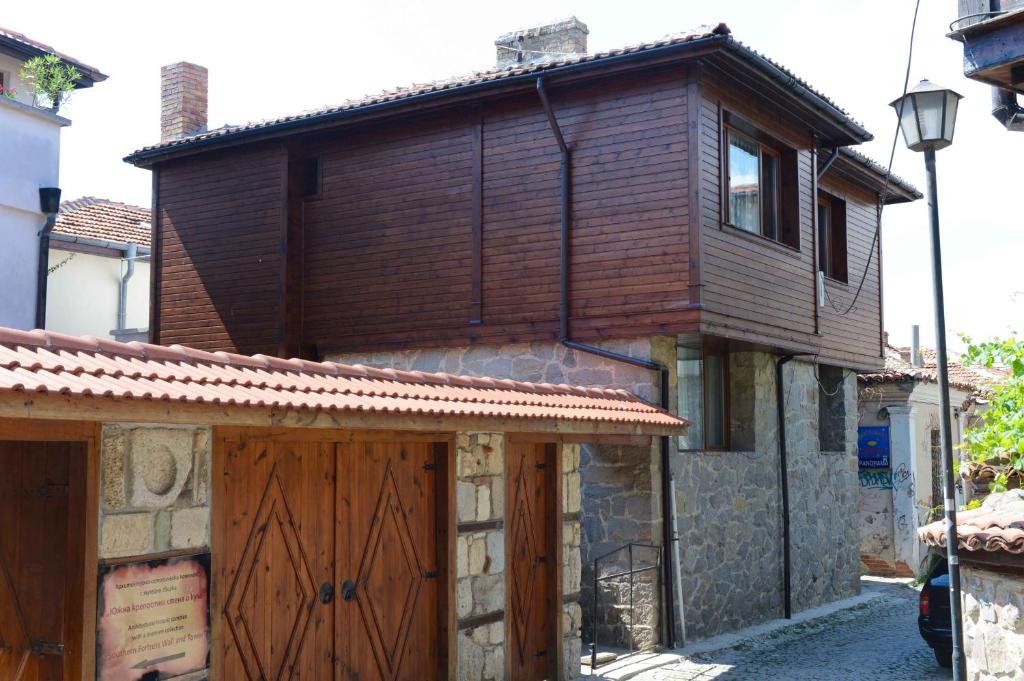 a house with a wooden roof and a garage at Villa MIA Sozopol in Sozopol