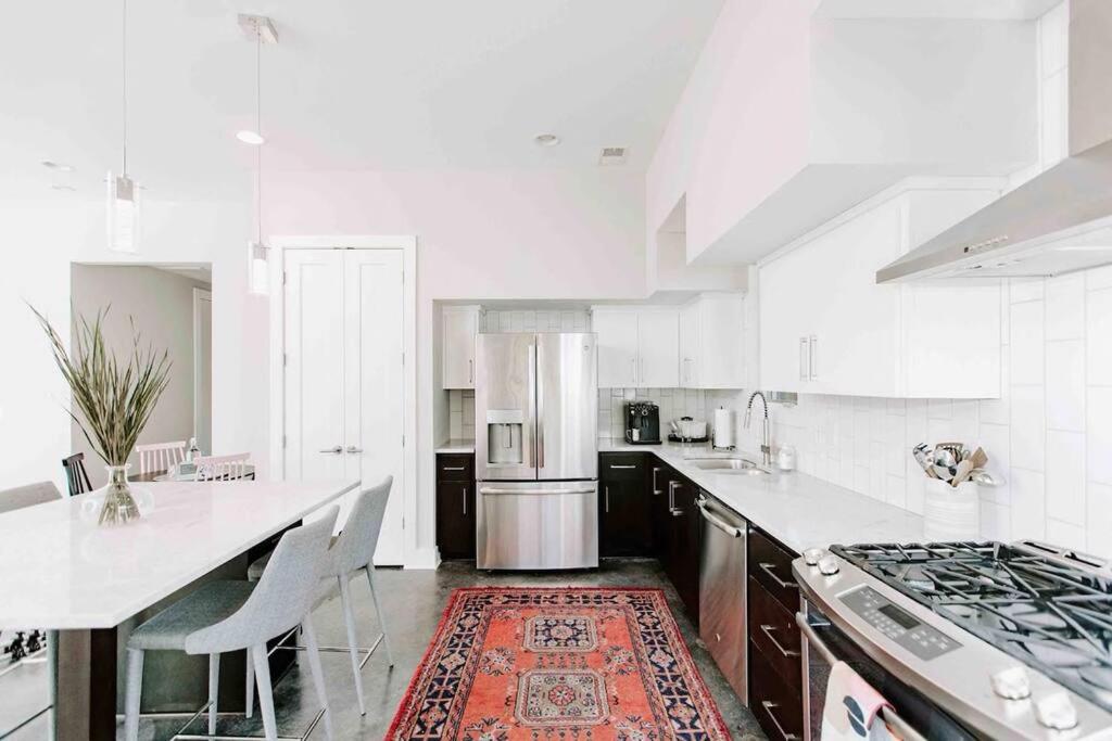 a kitchen with white counters and a stove top oven at Modern Luxury Rooftop Deck, 3 mi to Downtown in Nashville