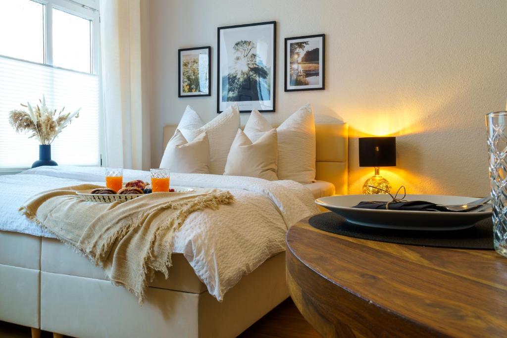 a bedroom with a bed and a table with drinks on it at Suite für 4 mit Terrasse im Herzen der Innenstadt in Schwerin