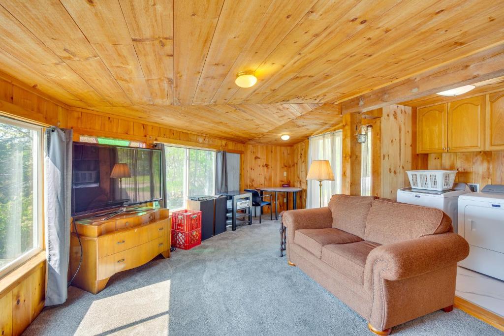 a living room in a tiny house with a couch at Beachfront Maine Retreat - Fire Pit, Grill and Canoe in Searsport