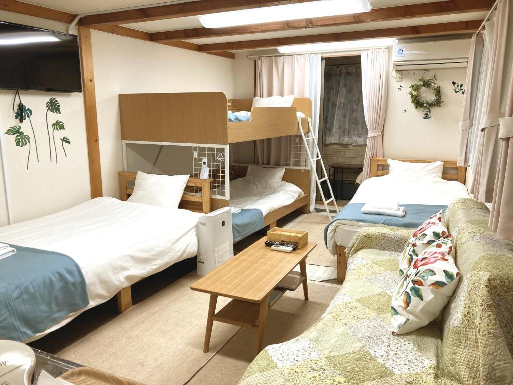 Postel nebo postele na pokoji v ubytování The Familiar Inn ー 旅館ホテル業