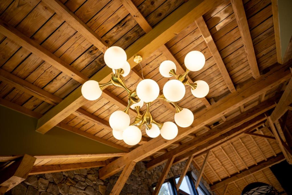 a chandelier hanging from a wooden ceiling at Le 11 des Bouchaux, Gîte d&#39;exception in La Bresse