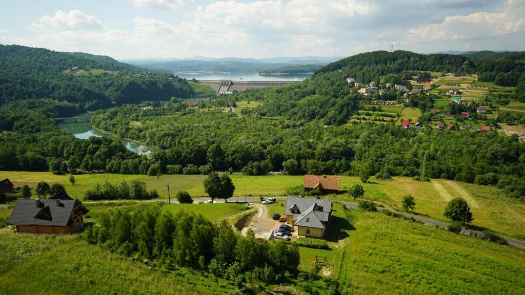 an aerial view of a village in a green field at Noclegi nad Soliną in Solina