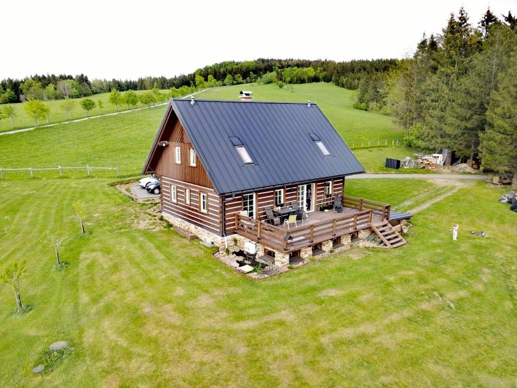 an aerial view of a log cabin in a field at Apartmán Kunst in Kořenov
