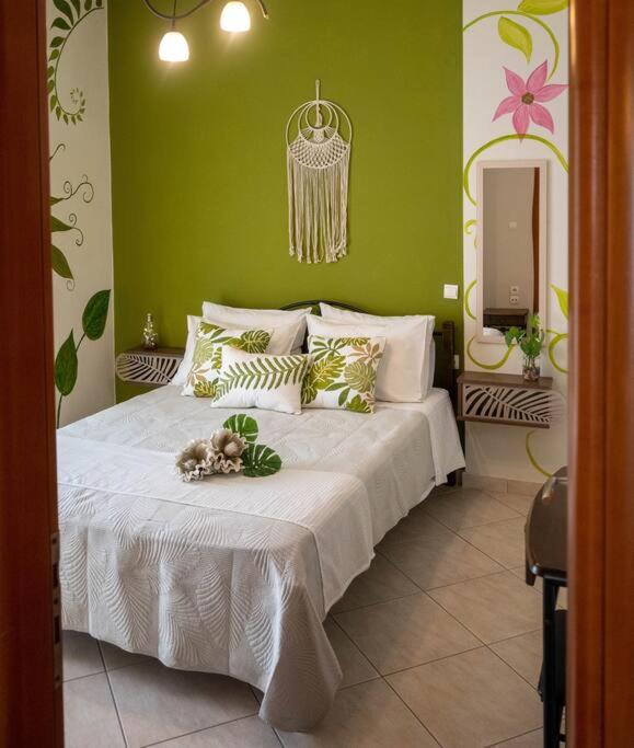 a dog laying on a bed in a bedroom at Πράσινη πινελιά διαμέρισμα in Kissamos