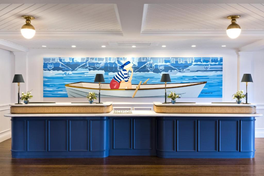 um bar num quarto com um barco na parede em White Elephant Hotel em Nantucket